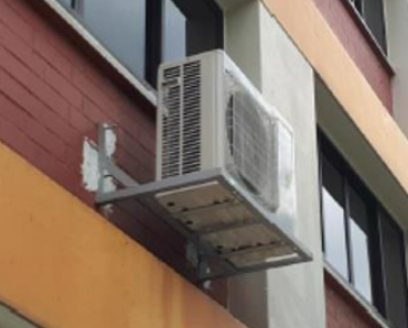 an air-conditioning unit with structural support on the exterior of a building